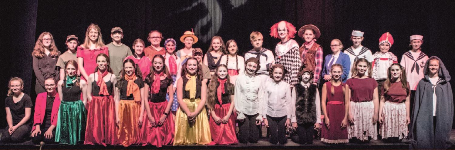 Large group of students in costume in a school production