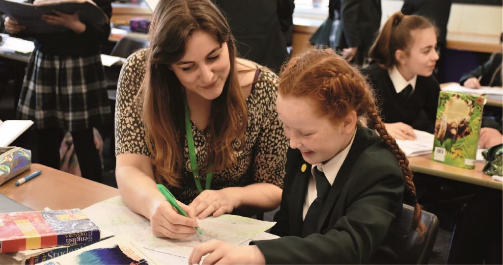 Picture of a teacher helping a student in class