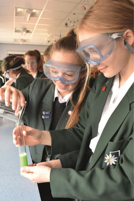 Students in protective equipment doing science experiments