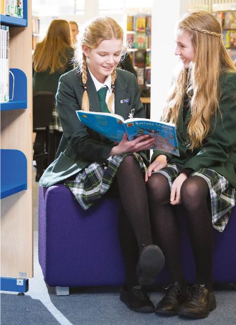 Two students reading in the library