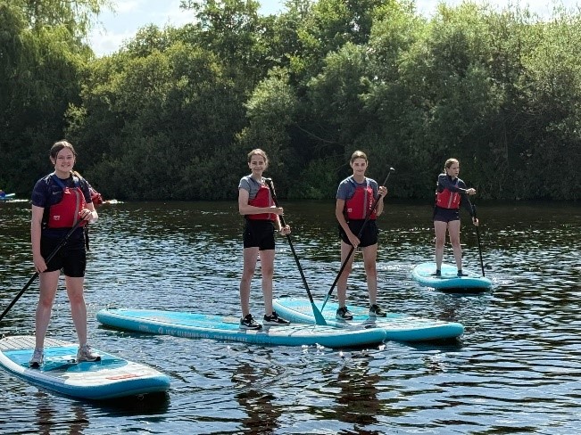 students paddleboarding