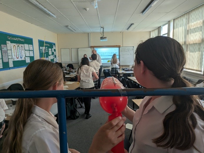 students taking part in squashed tomato challenge