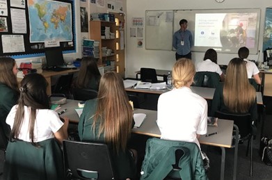 students in classroom discussing volunteering