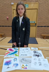 student showing their art
