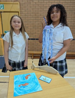 students showing paper art
