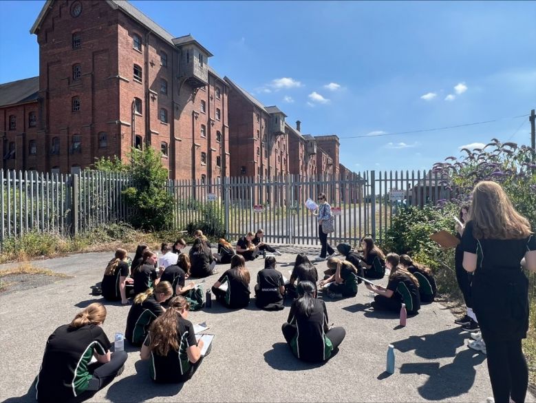students outside local historical building