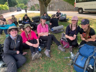 group of students relaxing in a field