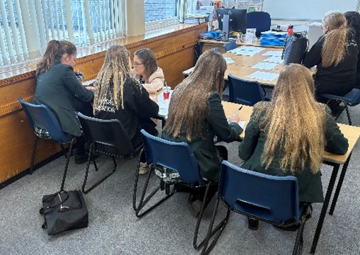 teacher guiding students doing maths tasks