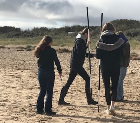 small group of students on beach