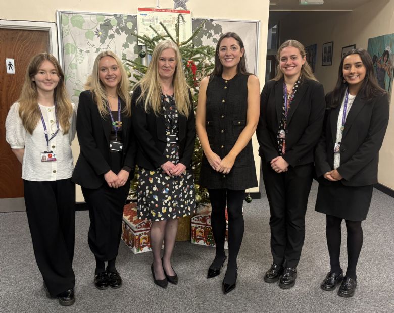 group of students with headteacher and guest speaker for prizegiving event