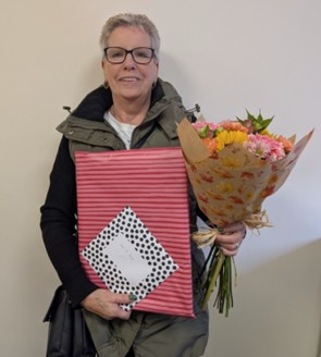 staff member with leaving gifts