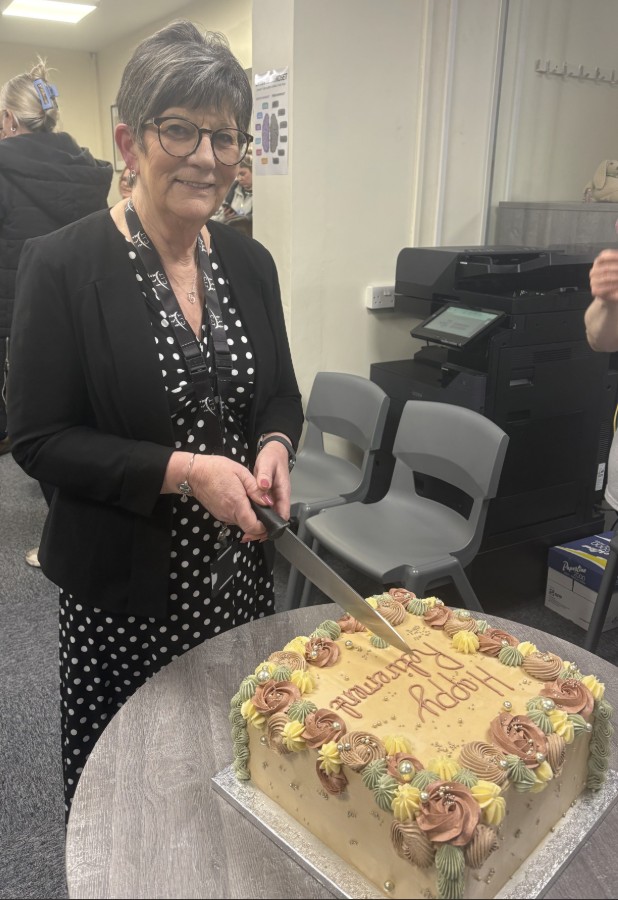 Mrs Porter, Office Manager cutting her retirement cake